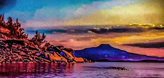 Landscape with mountains, trees, and a sunset over water