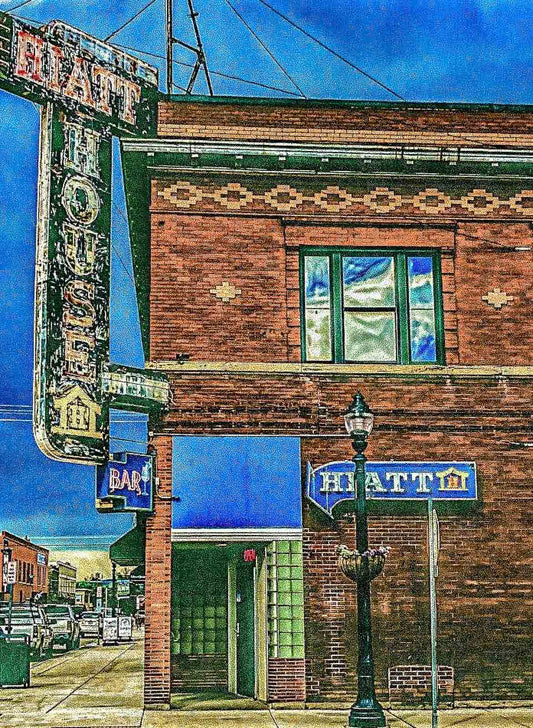 Brick building with 'Hatt' sign and streetlight, vintage feel