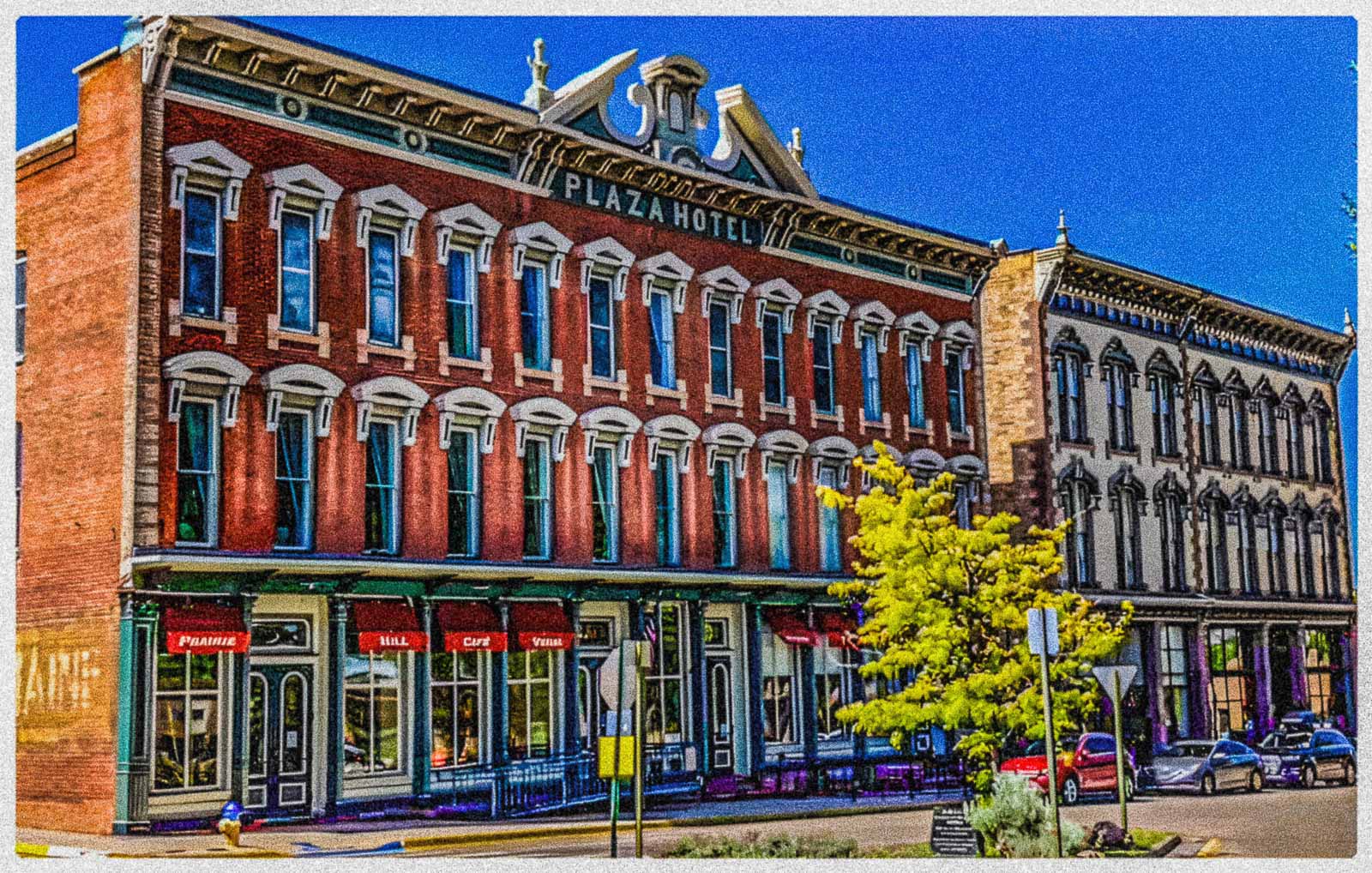 Historic Plaza Hotel building in Las Vegas, New Mexico with colorful facade under a clear blue sky.