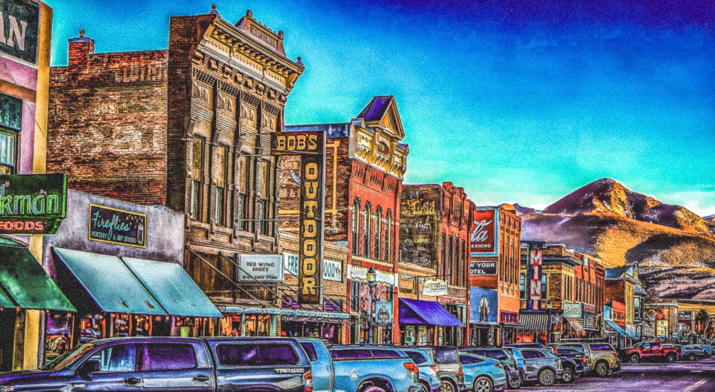 a famous main street scene with buildings and mountains in the background