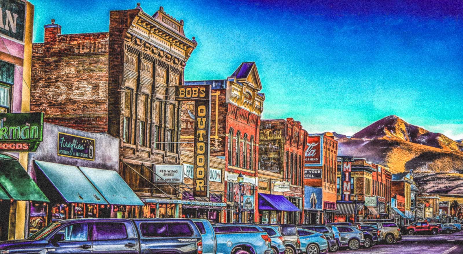 a famous main street scene with buildings and mountains in the background