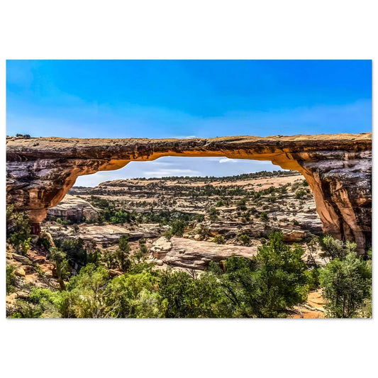 Natural rock arch with a scenic landscape in the background
