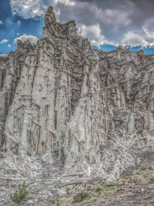 Stunning natural rock formation in Abiquiu, New Mexico with a blue sky and clouds in the background
