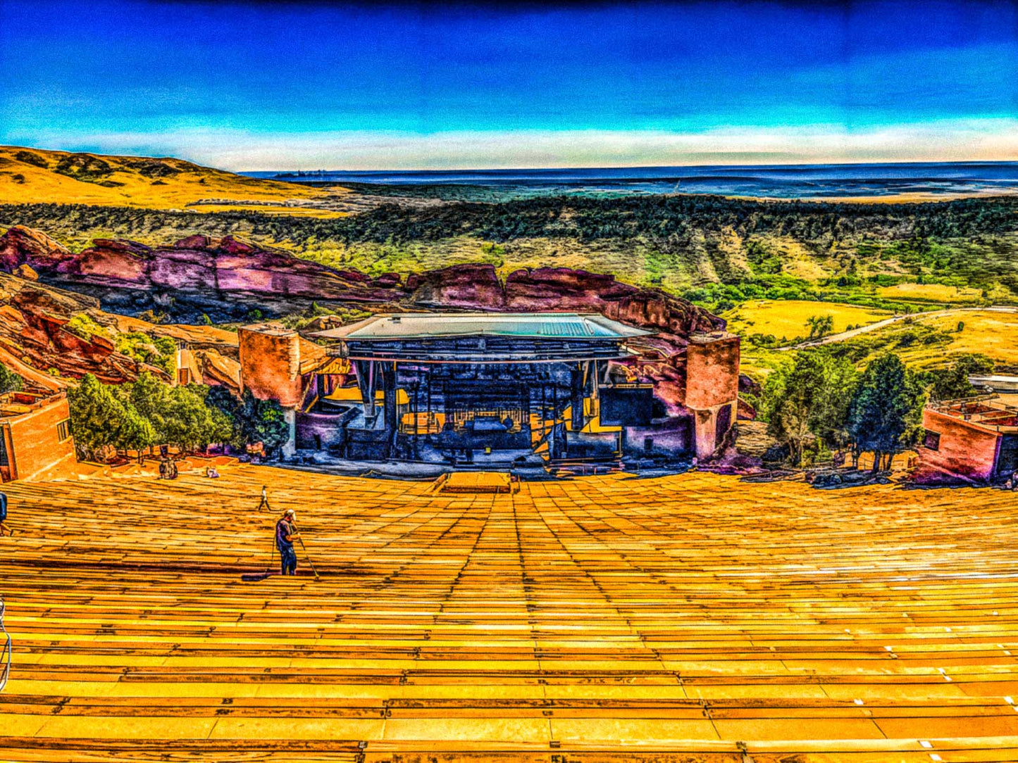 Red Rocks Amphitheater Morrison, Colorado with red rock formations and a clear blue sky.