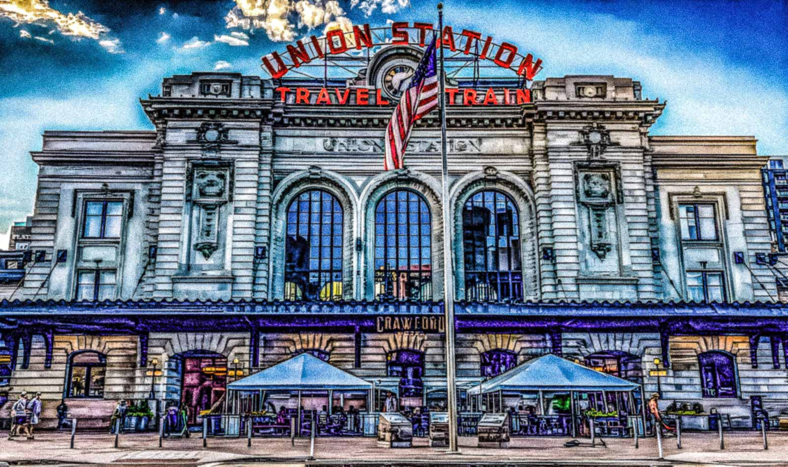 Denver, Colorado Union Station with a clear blue sky and American flag.